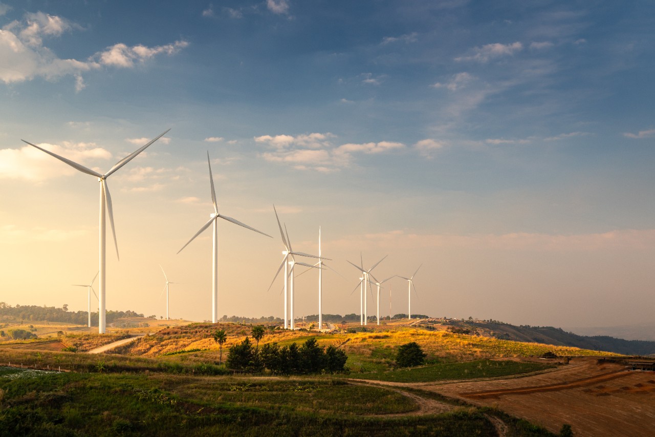 Wind turbines and Orange sunset sky. Beautiful mountain landscape with wind generators turbines,Thailand. Renewable energy concept. 